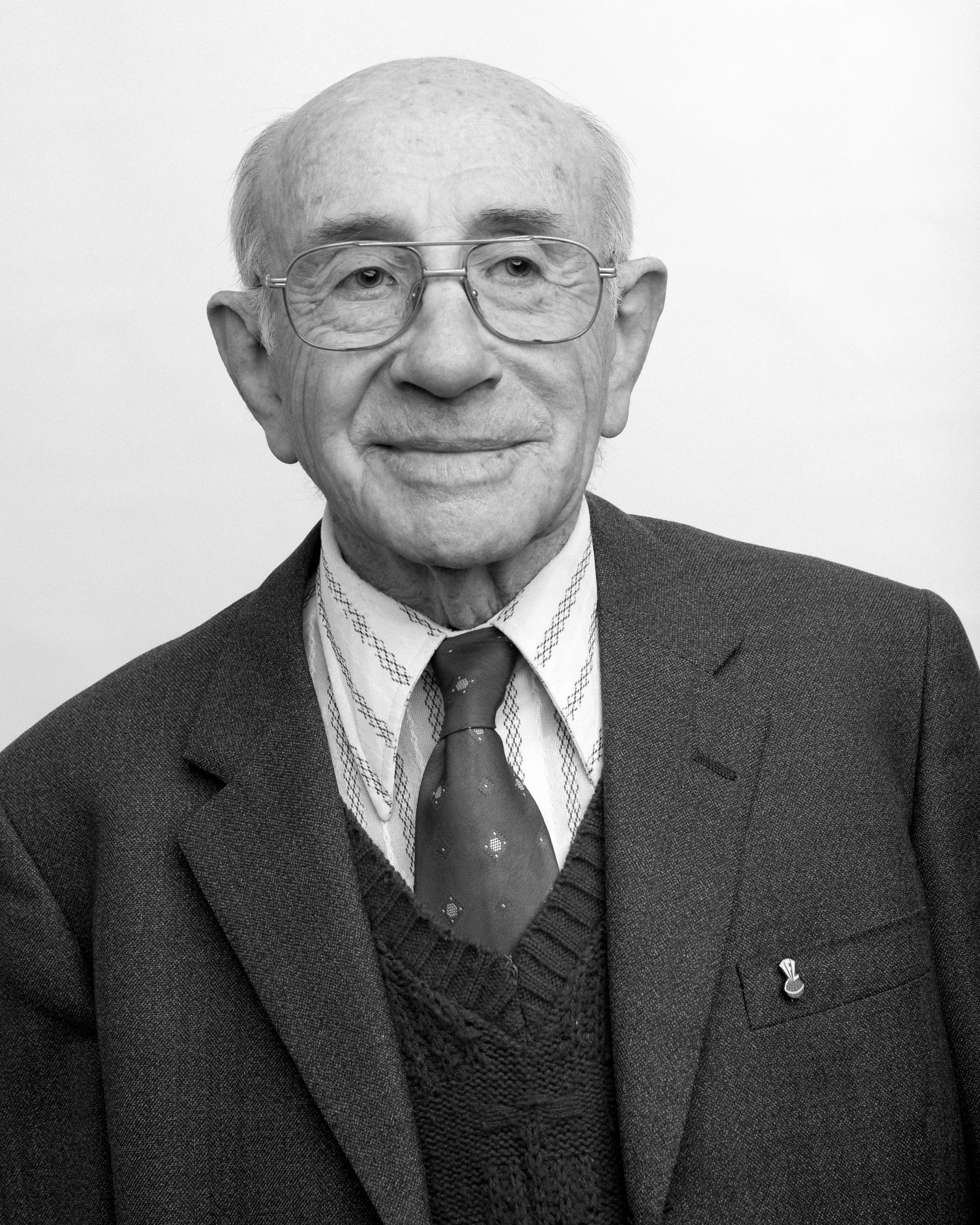 Black-and-white portrait of an older man in a suit