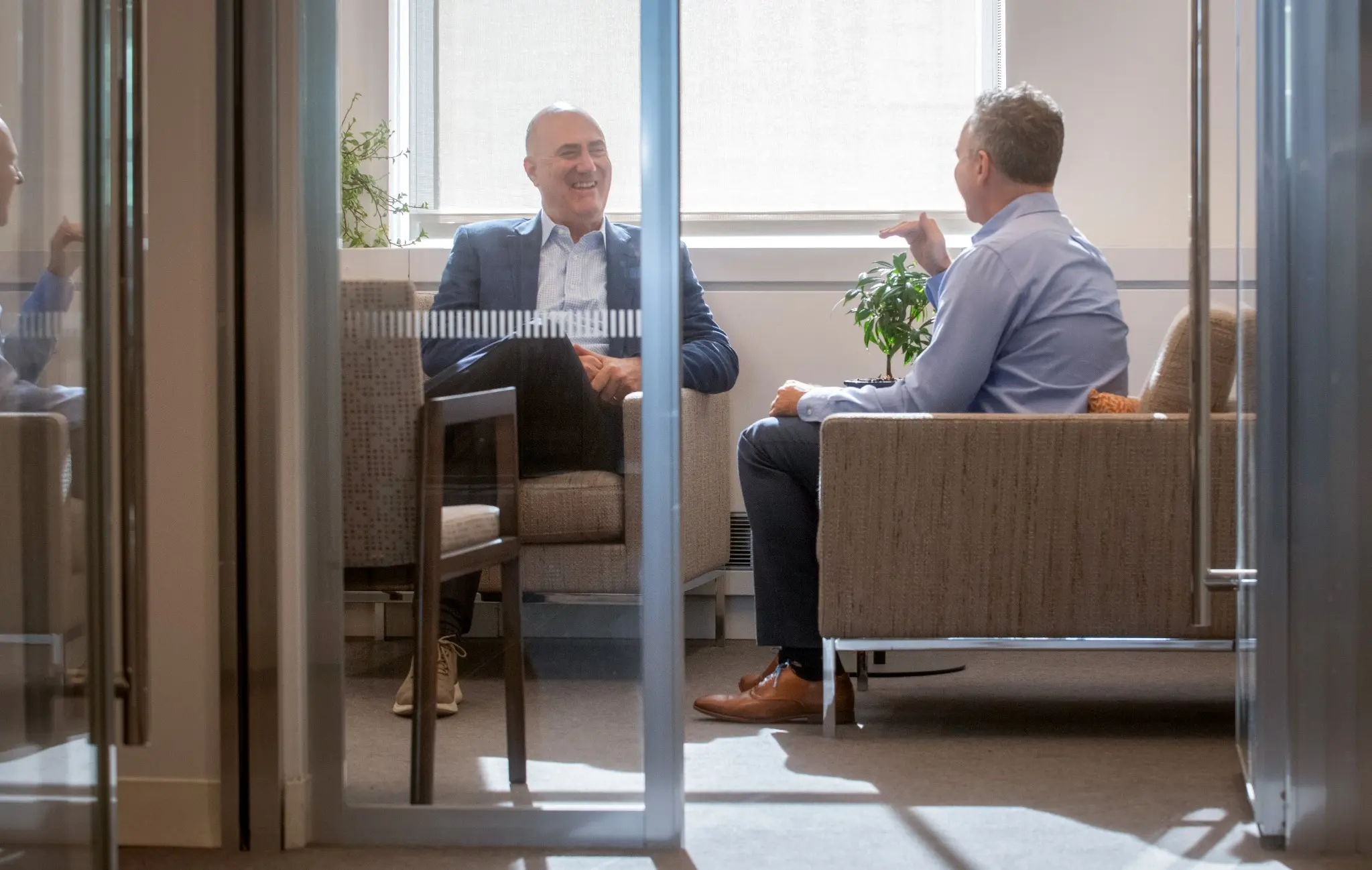 Brick & Patel team in a glass office